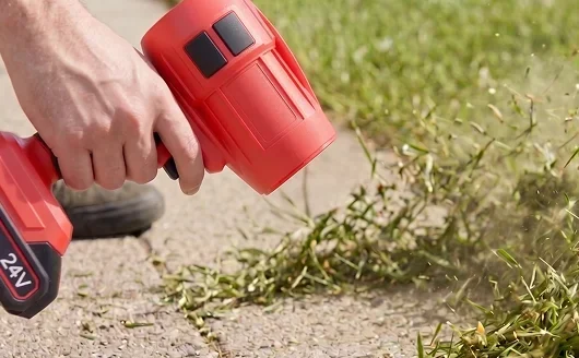 Blowing grass clippings off a driveway edge