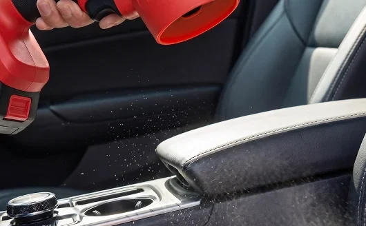 Blowing dust out of a car interior